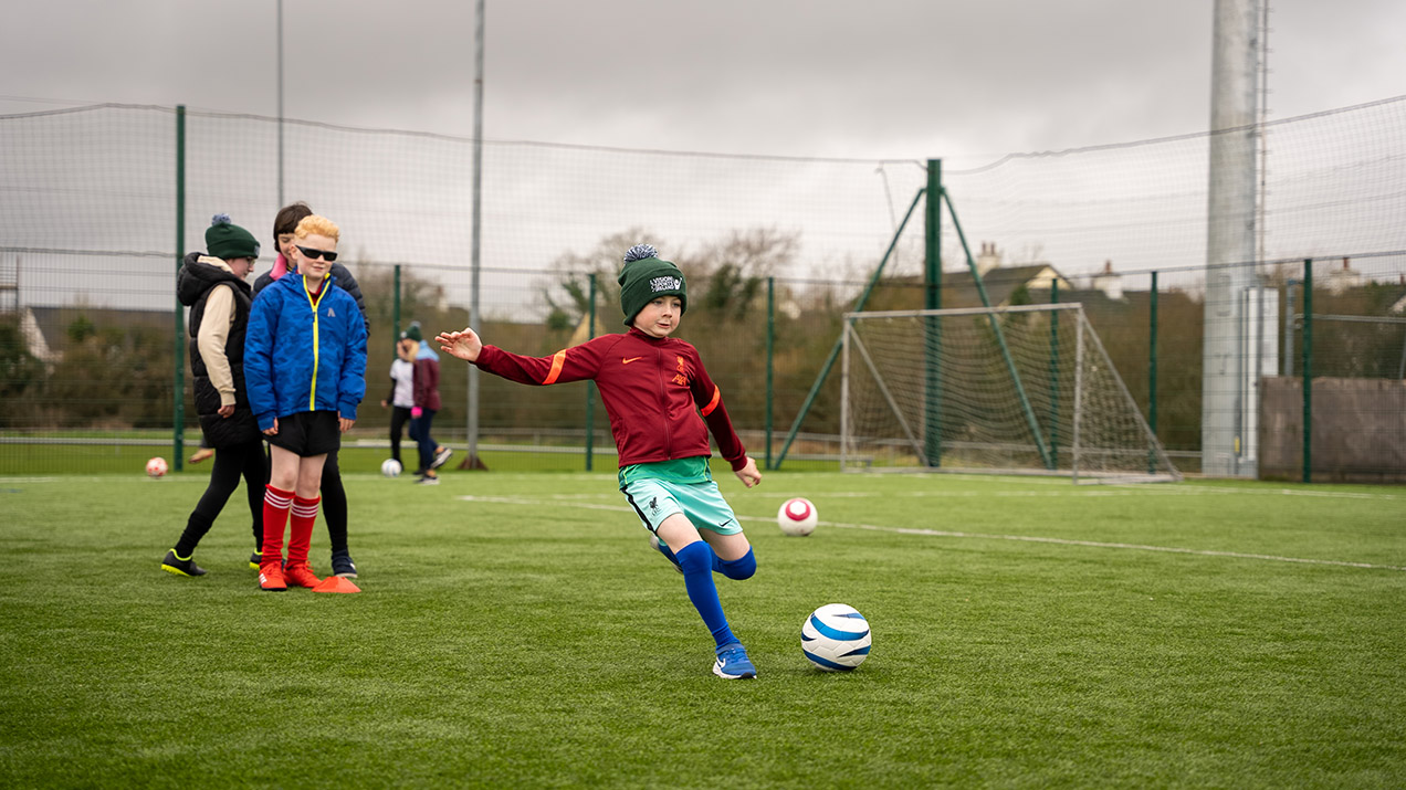 participant kicking a Football
