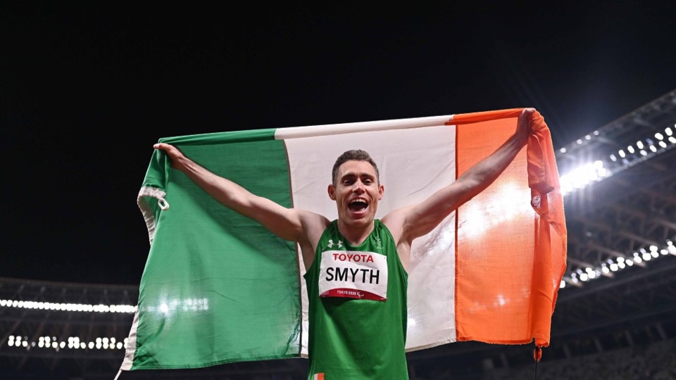 Paralympian holding the Irish flag