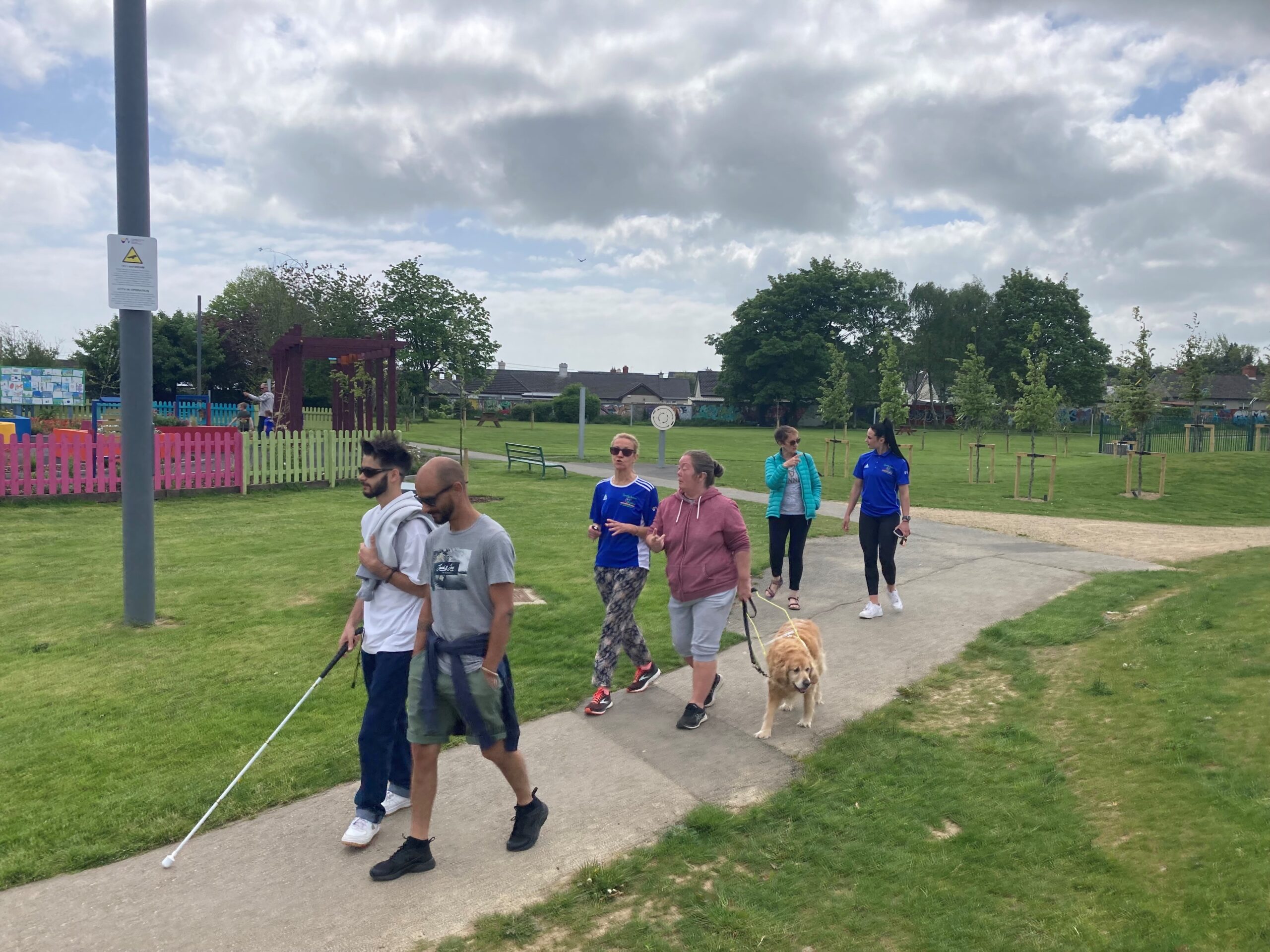 Participants walking on a park path.