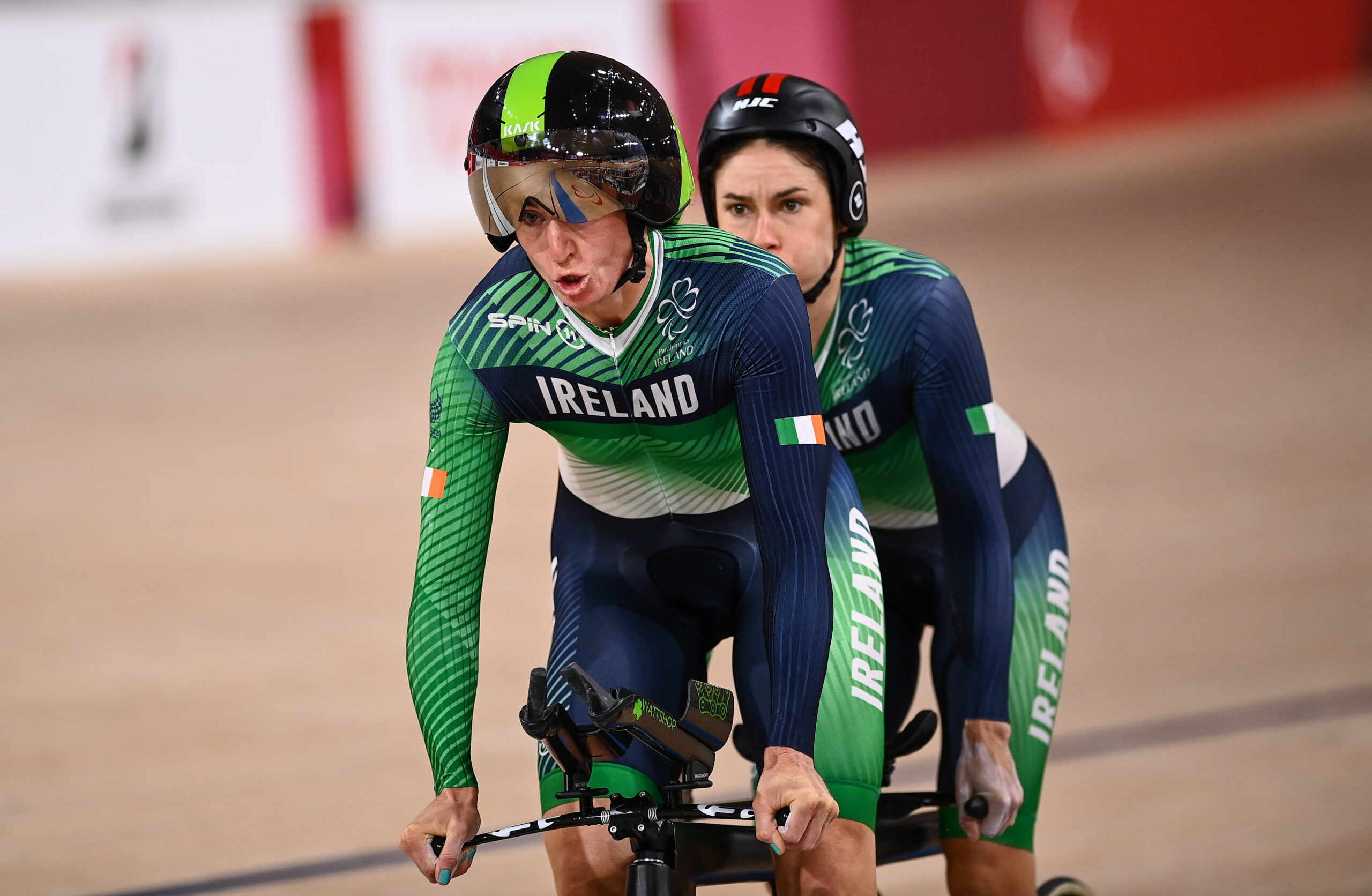 pilot and stoker on a tandem cycling in a velodrome
