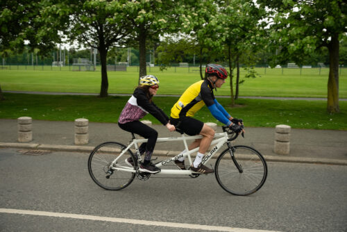 Photo of pilot and stoker on tandem bike.