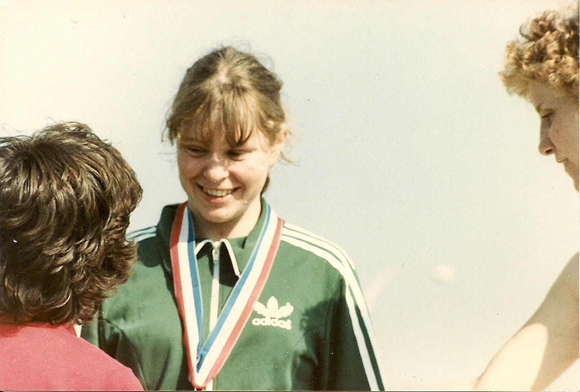 Old photo of a female getting presented with a medal