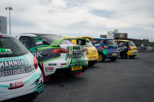 the back of multiple rally cars lined up
