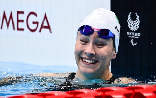 Swimmer smiling in the water after a race