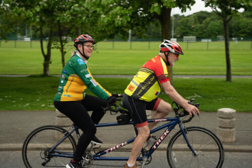 Photo of a man and a woman on a tandem bike