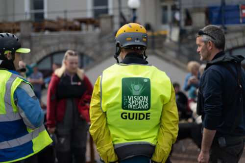 photo of a volunteer wearing a vision sports Ireland hi vis bib with the word guide on it