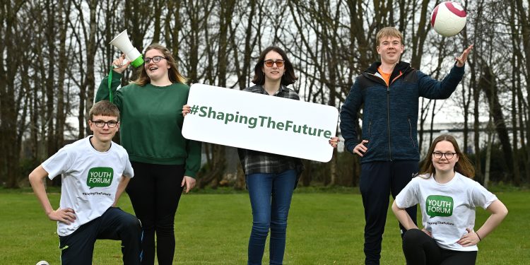 group photo of youth leadership participants holding a sign saying #shapingthefuture