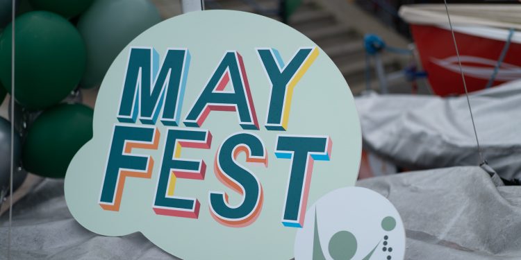 Mayfest logo on a cut out sign