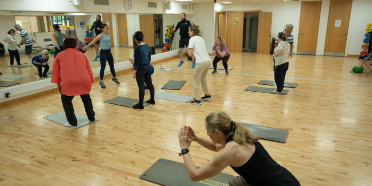 photo of a group partaking in a group exercise class