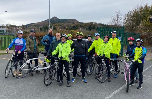 Gratuated of tandem pilot training course in bray Wheelers clubhouse car park posing with their tandem bikes after completion of course.