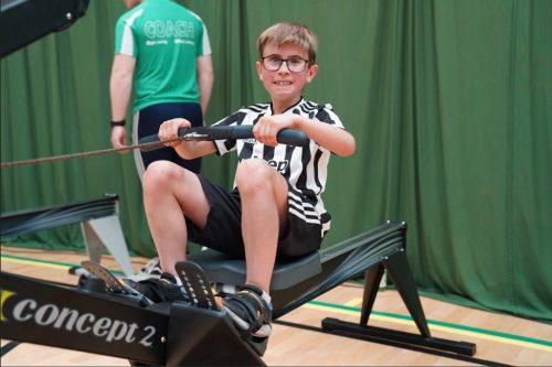 A child rowing on a rowing machine