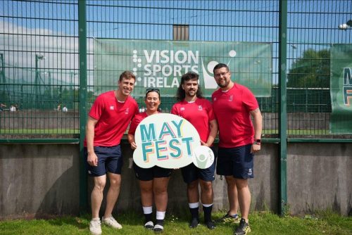 A group of 4 vi rugby players holding up a MayFest sign