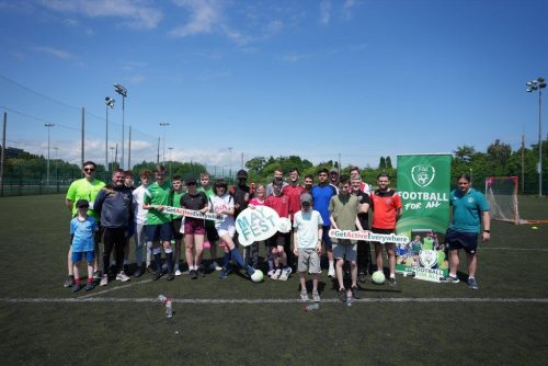 A group photo of participants at a Football for All session