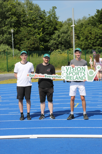 A group of three males holding a Vision Sports Ireland sign and a #GetActiveEverywhere sign