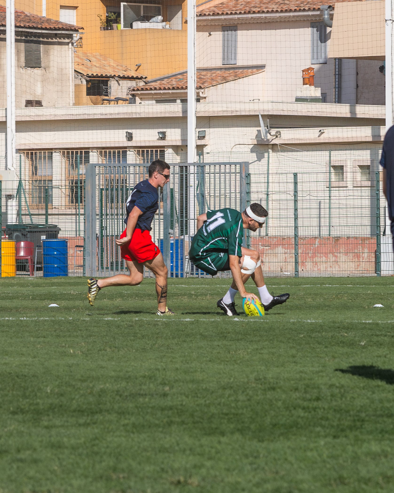 Rugby player in green kit scoring a try